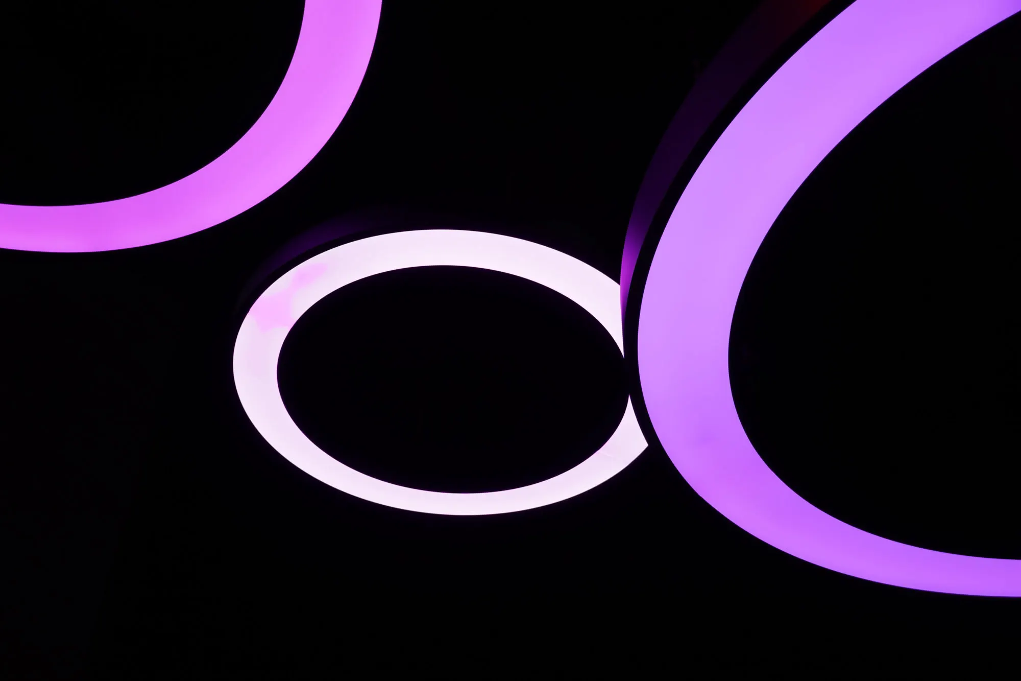 Acrylic and light: illuminated rings on a black background