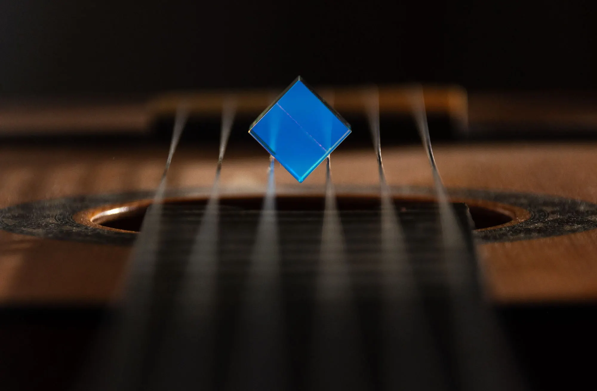 Acrylic for musical instruments: blue pick on guitar strings